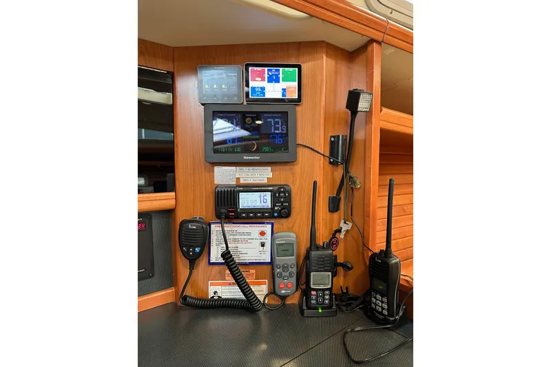 Slide: The Image of Control panel of a 2008 Hunter 49 yacht with communication devices and navigation instruments. - 90