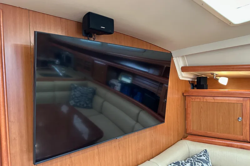 Slide: The Image of Flat-screen TV and speaker in 2008 Hunter 49 yacht interior with wood paneling. - 96