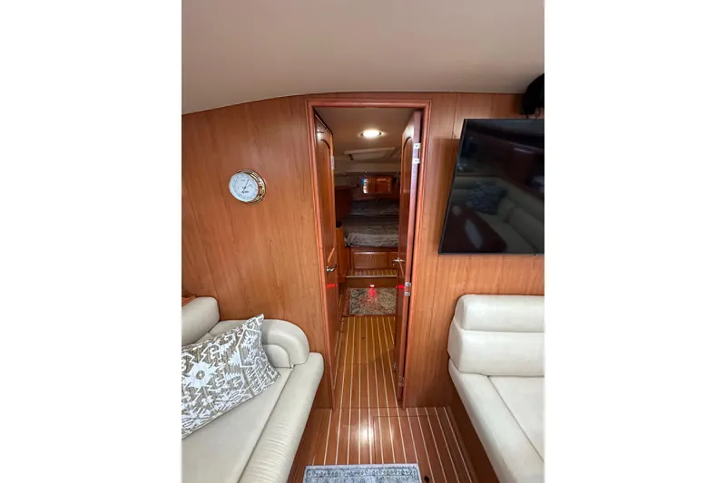 Slide: The Image of Interior of 2008 Hunter 49 yacht with wood paneling and cozy seating area. - 97