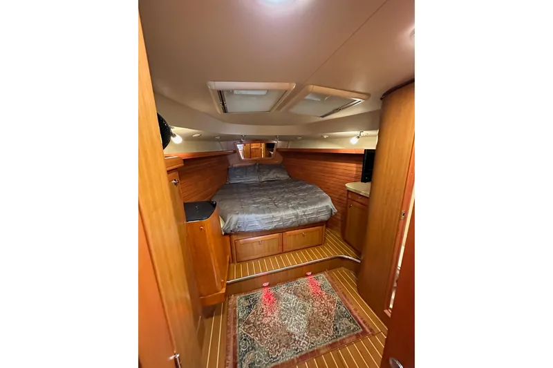 Slide: The Image of Luxurious cabin interior of 2008 Hunter 49 yacht with cozy bed and wooden finish. - 98