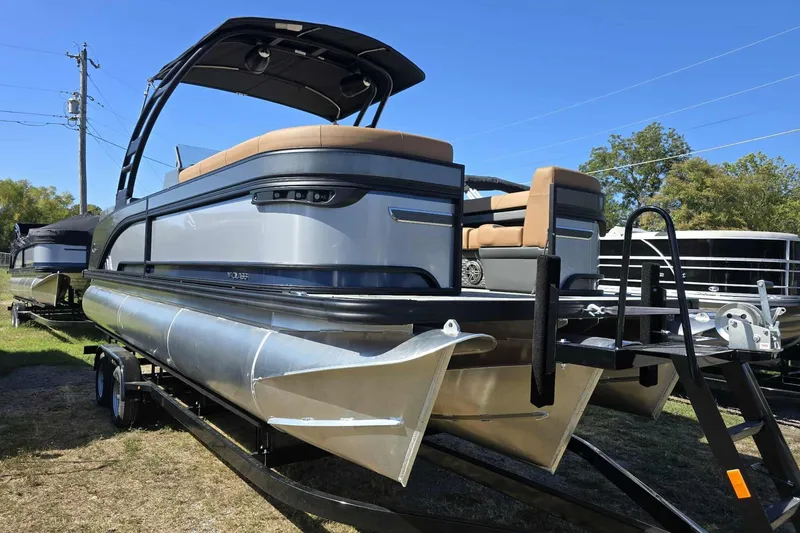 The Image of 2026 Qwest 22RLS pontoon boat on trailer, featuring sleek design and comfortable seating. - 1