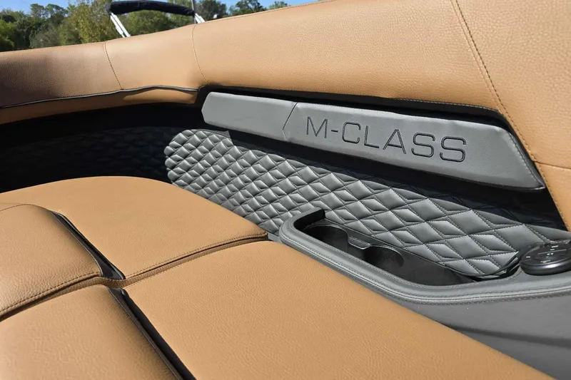 Slide: The Image of 2026 Qwest 22RLS M-Class interior with tan leather seats and quilted gray accents. - 10