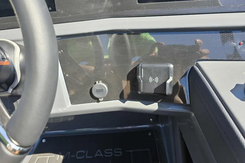 Slide: The Image of Dashboard of 2026 Qwest 22RLS with wireless charging pad and controls. - 12