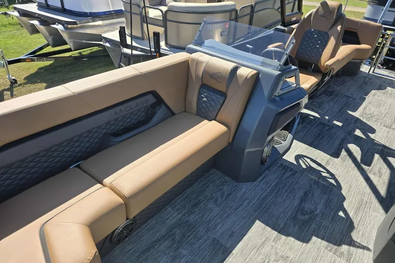 Slide: The Image of Luxurious interior of 2026 Qwest 22RLS pontoon boat with tan seating and modern design. - 4