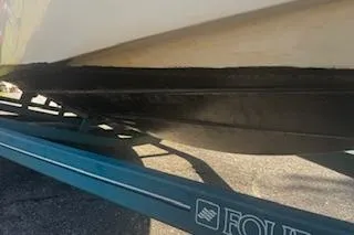 Slide: The Image of 1993 Four Winns 190 Horizon boat on trailer, close-up view of hull and trailer. - 13