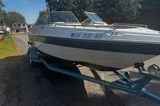 Slide: The Image of 1993 Four Winns 190 Horizon boat on trailer, parked outdoors. - 3