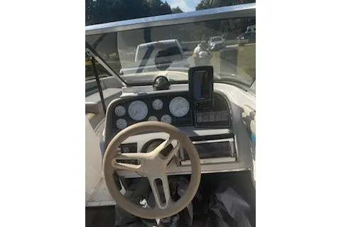 Slide: The Image of 1993 Four Winns 190 Horizon boat dashboard with steering wheel and gauges. - 9