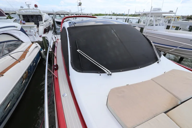 Slide: The Image of 2020 Azimut Nexus X47 yacht docked at marina, featuring sleek design and sunbathing area. - 12