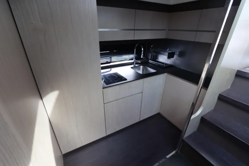 Slide: The Image of Modern kitchen interior of 2020 Azimut Nexus X47 yacht, featuring sleek cabinetry and appliances. - 26