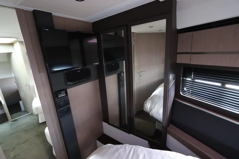 Slide: The Image of Interior of 2020 Azimut Nexus X47 yacht with TV, mirror, and modern furnishings. - 30