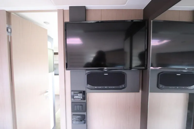 Slide: The Image of Entertainment system inside 2020 Azimut Nexus X47 yacht, featuring a mounted TV and sound system. - 31