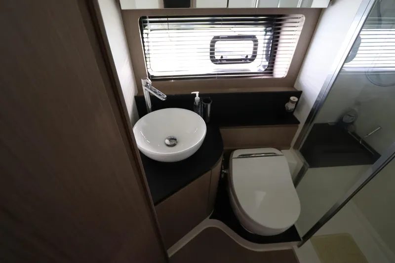 Slide: The Image of Modern bathroom in 2020 Azimut Nexus X47 yacht with sink, toilet, and window blinds. - 32