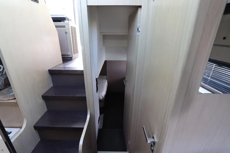 Slide: The Image of Interior view of 2020 Azimut Nexus X47 yacht, featuring stairs and a compact cabin space. - 38