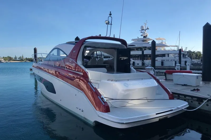 Slide: The Image of Azimut Nexus X47 2020 luxury yacht docked at marina, sleek design, red and white exterior. - 4