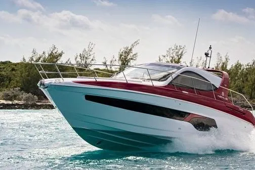Slide: The Image of 2020 Azimut Nexus X47 yacht cruising on clear blue water near lush greenery. - 46