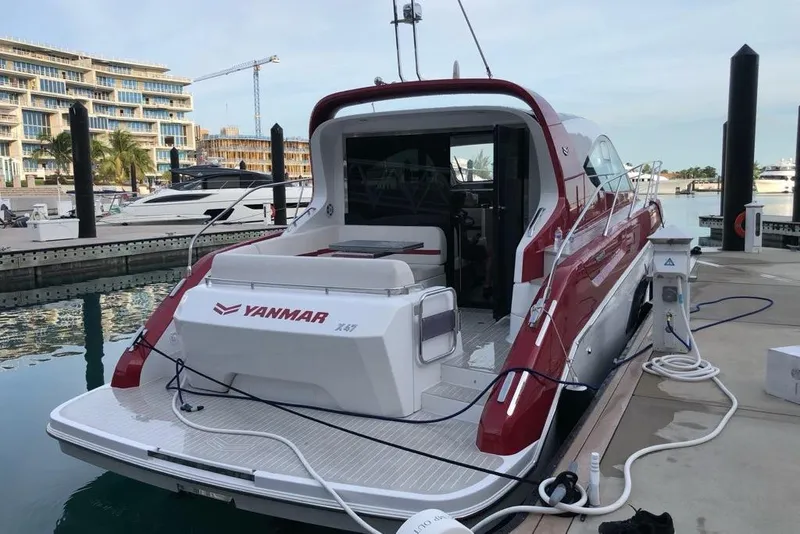 Slide: The Image of Azimut Nexus X47 2020 yacht docked at marina, featuring sleek red and white design. - 6