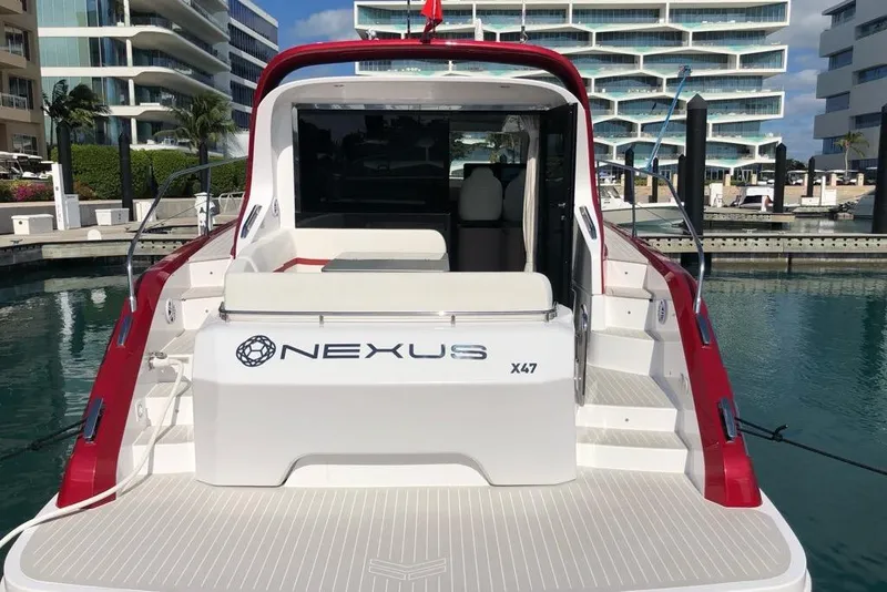 Slide: The Image of Azimut Nexus X47 yacht, 2020 model, docked at a marina with modern buildings. - 7