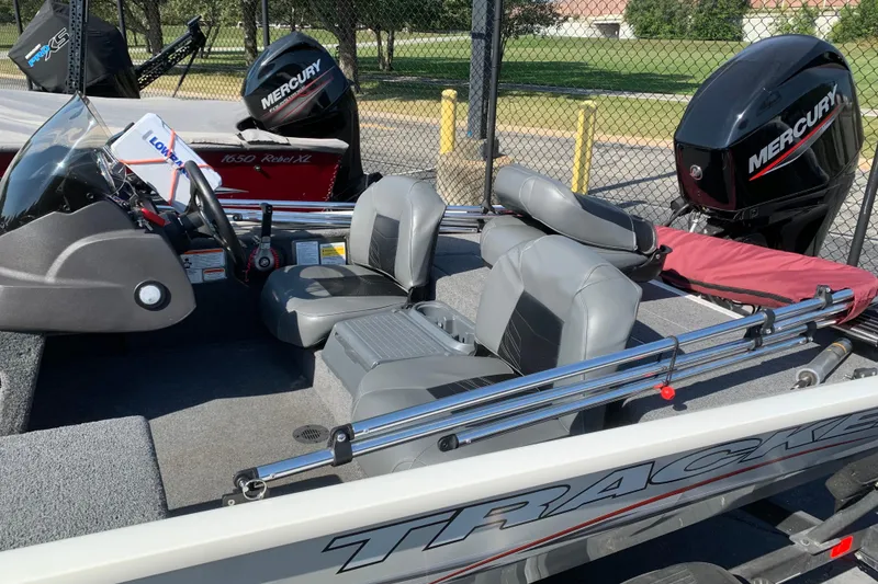 Slide: The Image of 2023 Tracker Pro 170 boat on trailer, parked outdoors, ready for fishing adventures. - 2