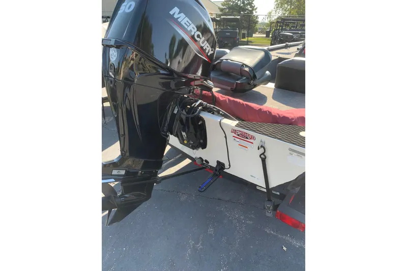 Slide: The Image of 2023 Tracker Pro 170 boat with steering wheel and seating, parked outdoors. - 4