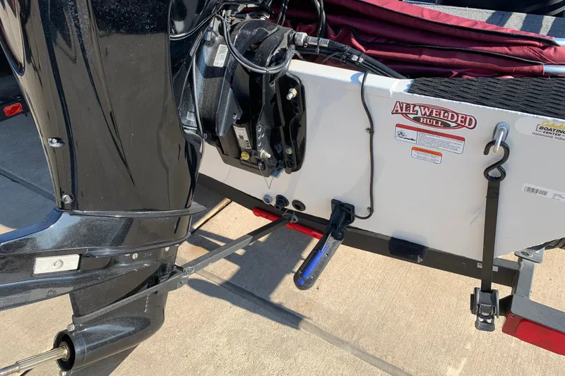 Slide: The Image of 2023 Tracker Pro 170 boat with all-welded hull and motor, parked on a trailer. - 7