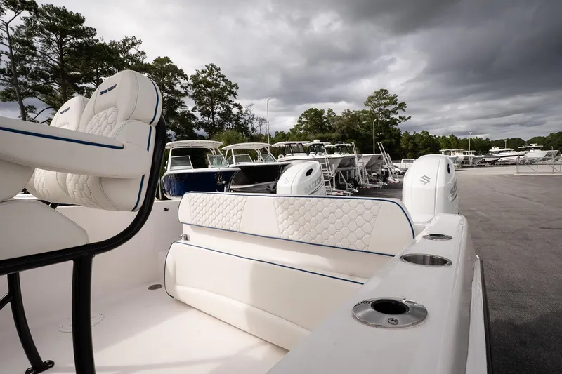 Slide: The Image of 2025 Twin Vee 240 GFX CC boat interior with plush seating and dual engines. - 11