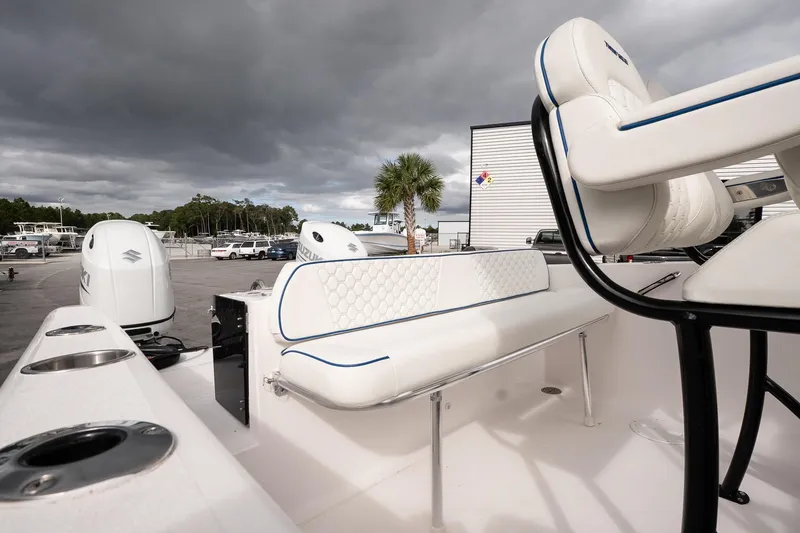 Slide: The Image of 2025 Twin Vee 240 GFX CC boat interior with white seating and Suzuki engines. - 12
