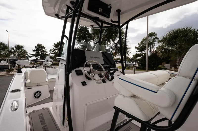 Slide: The Image of 2025 Twin Vee 240 GFX CC boat interior with steering console and seating. - 15