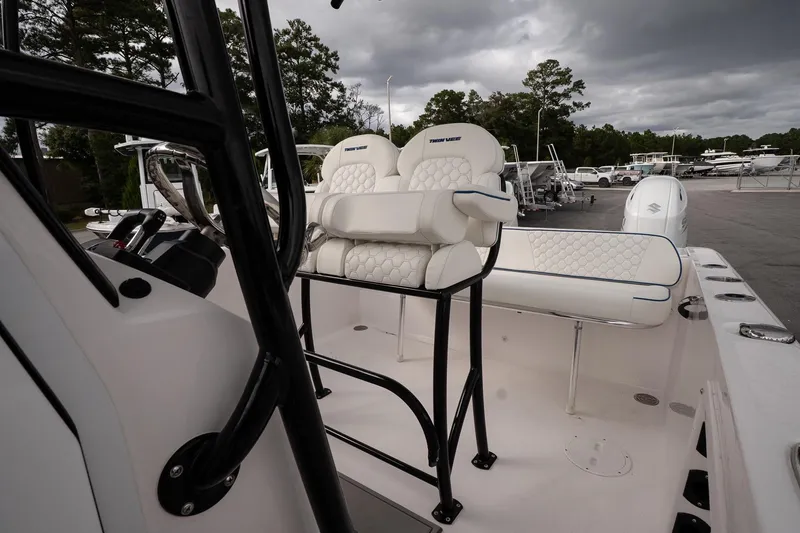 Slide: The Image of 2025 Twin Vee 240 GFX CC boat interior with plush seating and modern controls. - 16