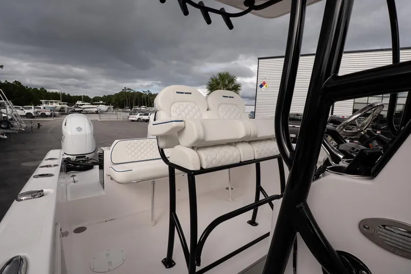 Slide: The Image of 2025 Twin Vee 240 GFX CC boat interior with cushioned seating and modern controls. - 17