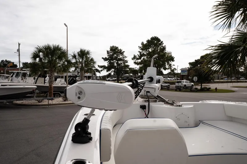 Slide: The Image of 2025 Twin Vee 240 GFX CC boat with motor, parked near palm trees. - 19