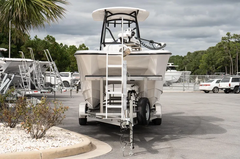Slide: The Image of 2025 Twin Vee 240 GFX CC boat on trailer in parking lot, cloudy sky background. - 3