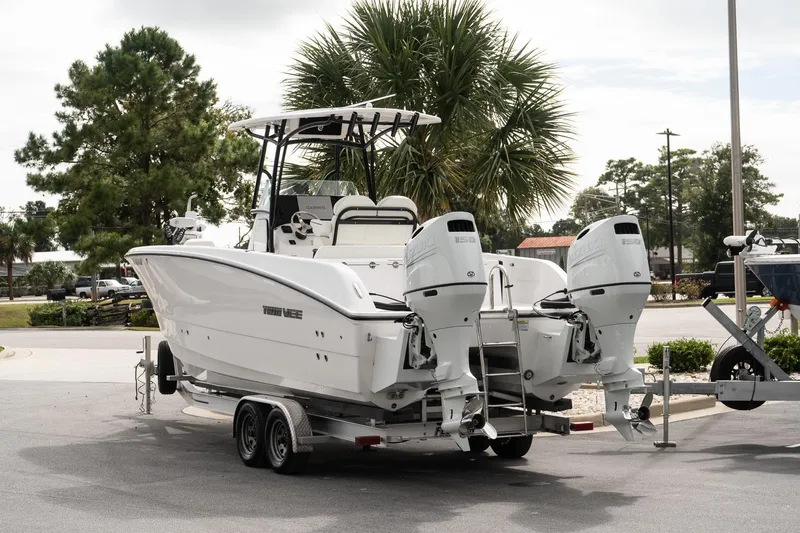 Slide: The Image of 2025 Twin Vee 240 GFX CC boat on trailer with dual outboard engines. - 4