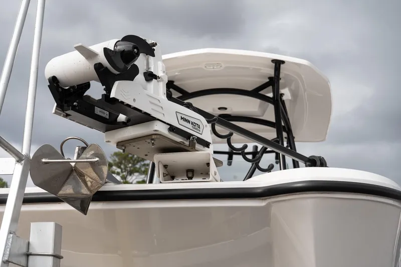 Slide: The Image of 2025 Twin Vee 240 GFX CC boat with Minn Kota trolling motor, cloudy sky background. - 8