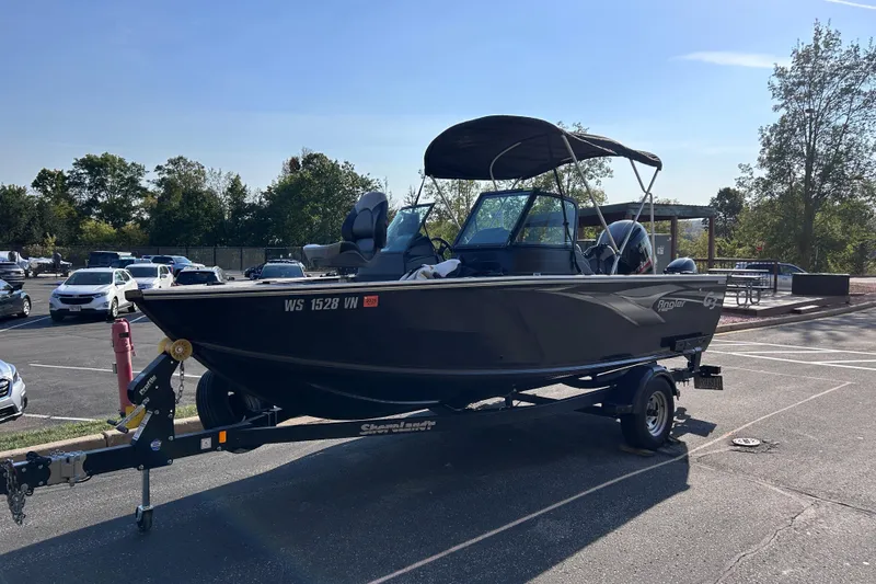 The Image of 2022 G3 Angler boat on trailer in parking lot, sunny day. - 0