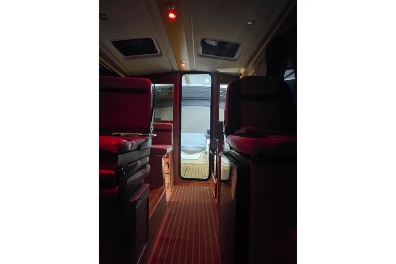 Slide: The Image of Interior view of 2015 Cutwater C28 boat with red lighting and wooden flooring. - 16