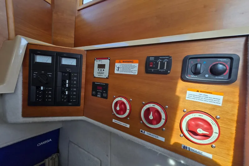 Slide: The Image of Control panel of a 2015 Cutwater C28 boat with switches and warning labels. - 20
