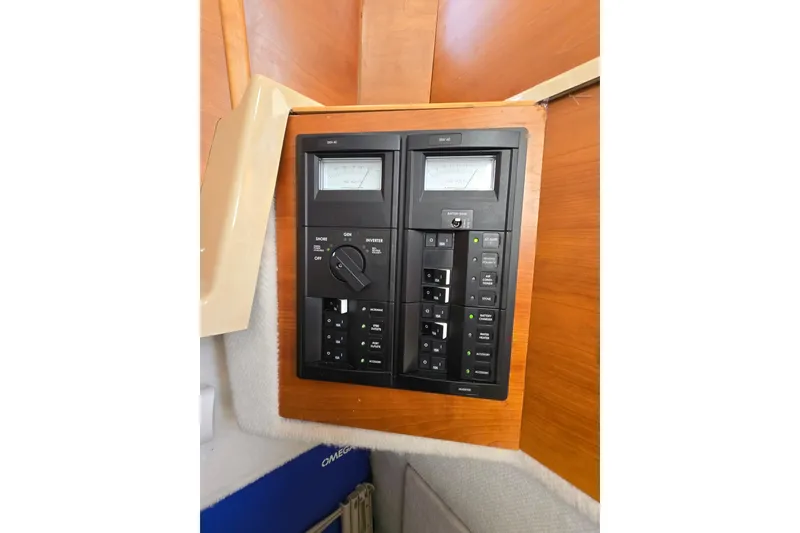 Slide: The Image of Electrical control panel on a 2015 Cutwater C28 boat, featuring switches and meters. - 21