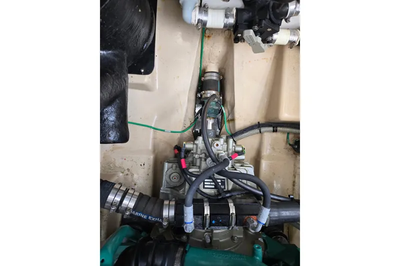 Slide: The Image of Engine compartment of a 2015 Cutwater C28 boat, showing hoses and mechanical components. - 24