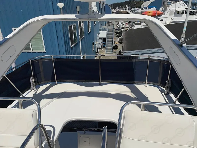 Slide: The Image of 1999 Bayliner 3388 Command Bridge Motoryacht deck with railing, docked at marina. - 10