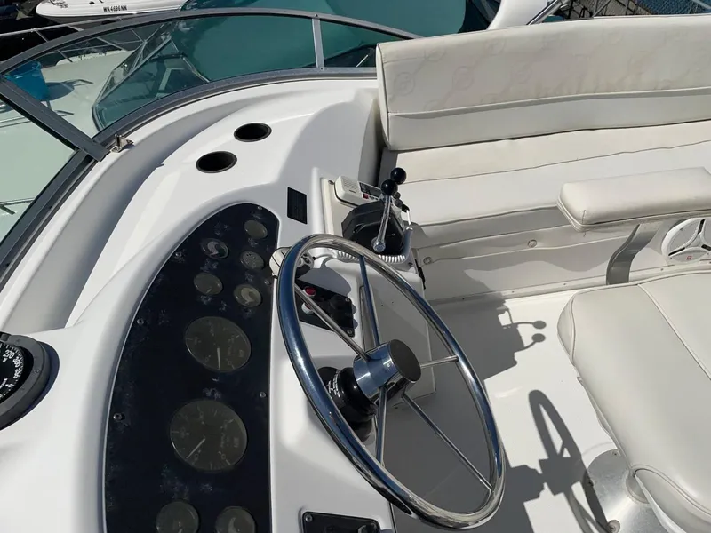 Slide: The Image of 1999 Bayliner 3388 Command Bridge Motoryacht helm with steering wheel and control panel. - 11