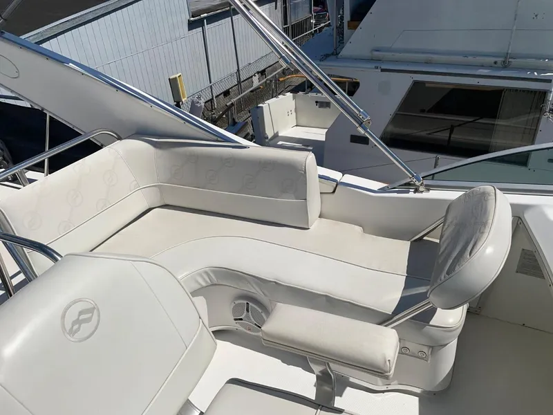 Slide: The Image of 1999 Bayliner 3388 Command Bridge Motoryacht with white seating on deck. - 13
