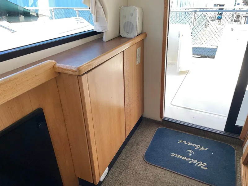 Slide: The Image of Interior of 1999 Bayliner 3388 Motoryacht with wooden cabinetry and deck access. - 17