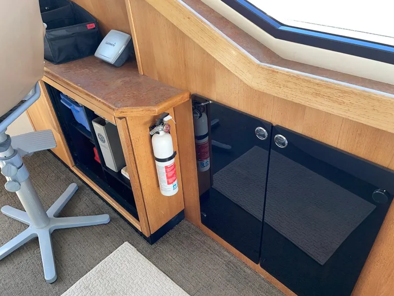 Slide: The Image of Interior of 1999 Bayliner 3388 Motoryacht with storage cabinets and fire extinguisher. - 18