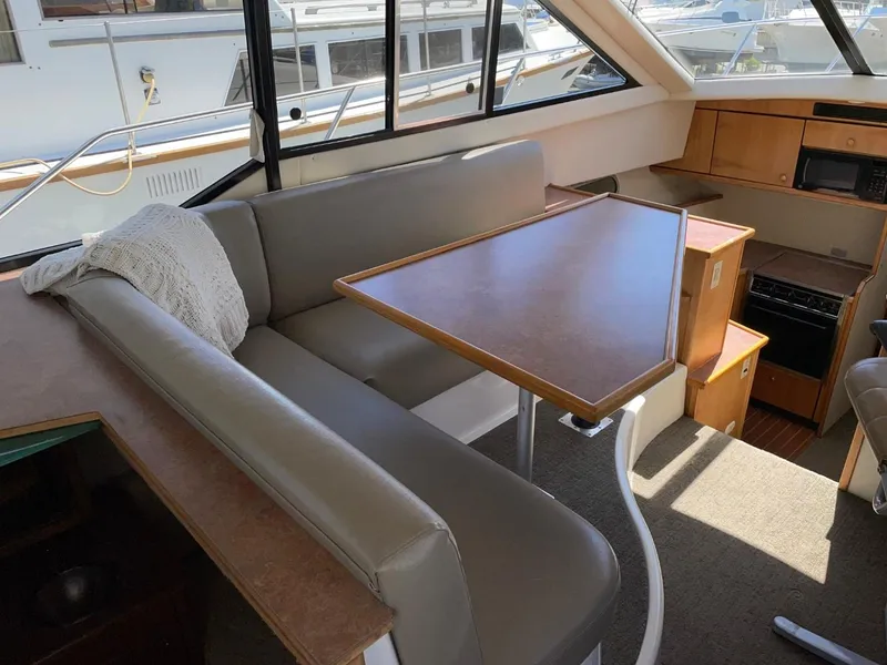 Slide: The Image of Interior of a 1999 Bayliner 3388 Motoryacht with dining area and kitchen. - 20