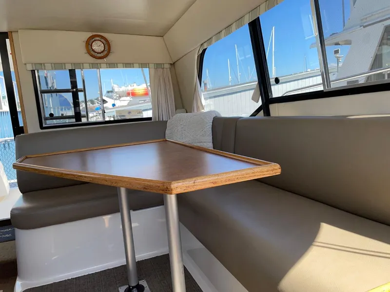 Slide: The Image of Interior of 1999 Bayliner 3388 Motoryacht with dining table and seating area. - 21
