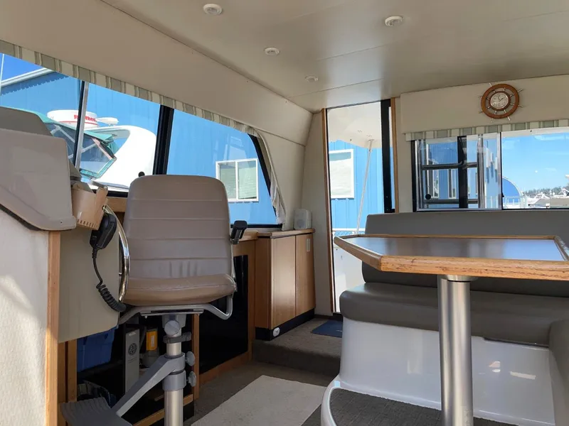 Slide: The Image of Interior of 1999 Bayliner 3388 Motoryacht with helm, seating, and dining area. - 22