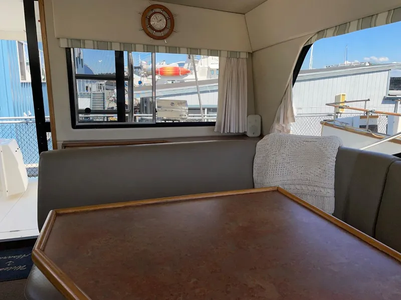 Slide: The Image of Interior of 1999 Bayliner 3388 Motoryacht with dining table and marina view. - 31