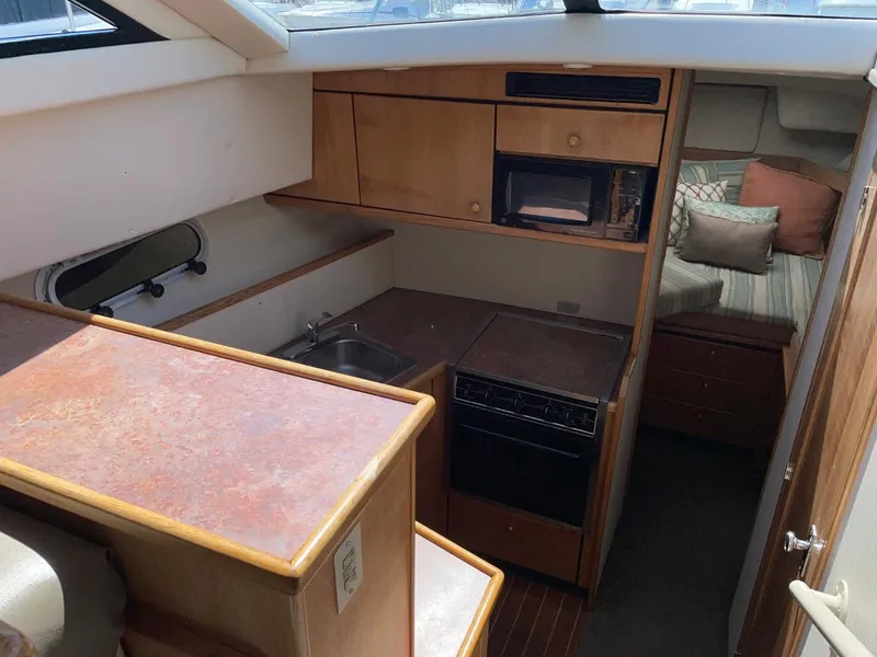 Slide: The Image of 1999 Bayliner 3388 Motoryacht interior kitchen and sleeping area. - 32