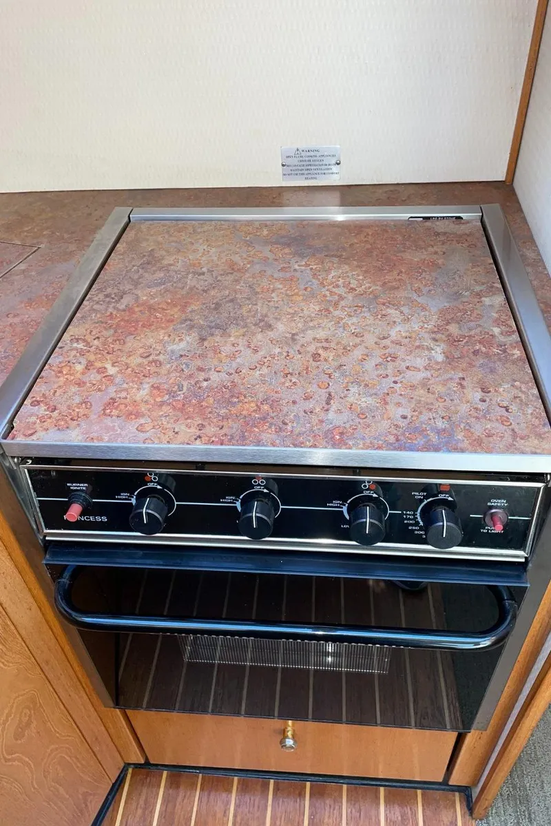 Slide: The Image of 1999 Bayliner 3388 Motoryacht kitchen stove and oven. - 34