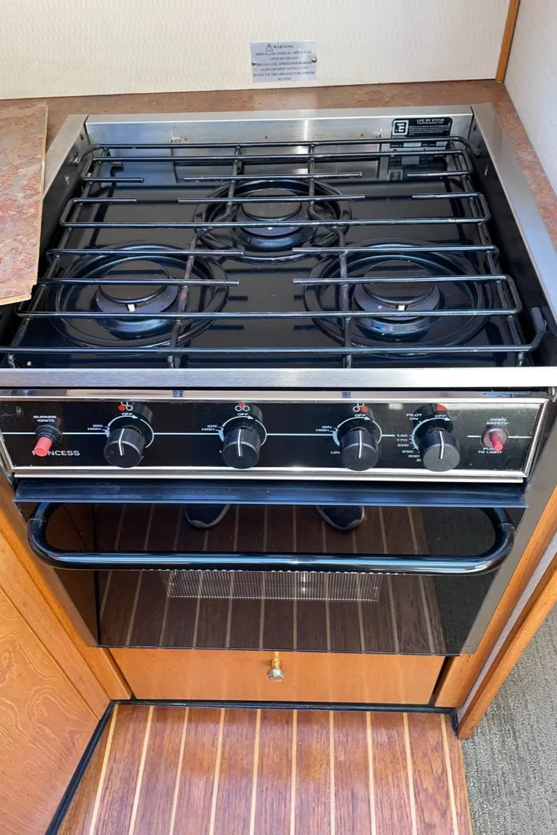 Slide: The Image of 1999 Bayliner 3388 Motoryacht kitchen stove with four burners and oven. - 35